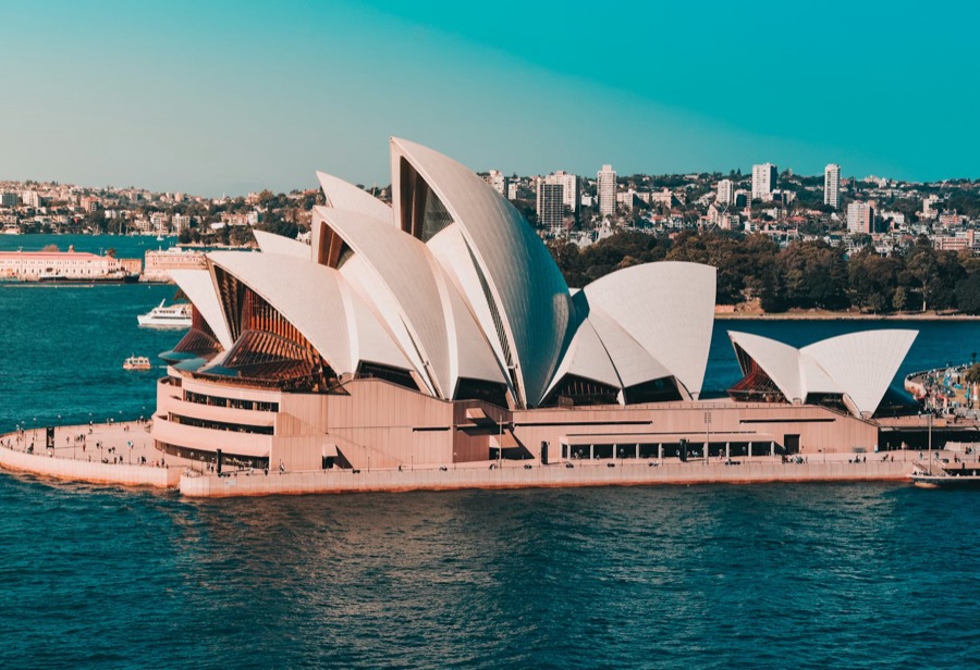 The iconic white shell-shaped sails of the Sydney Opera House against the harbour, Sydney, Australia